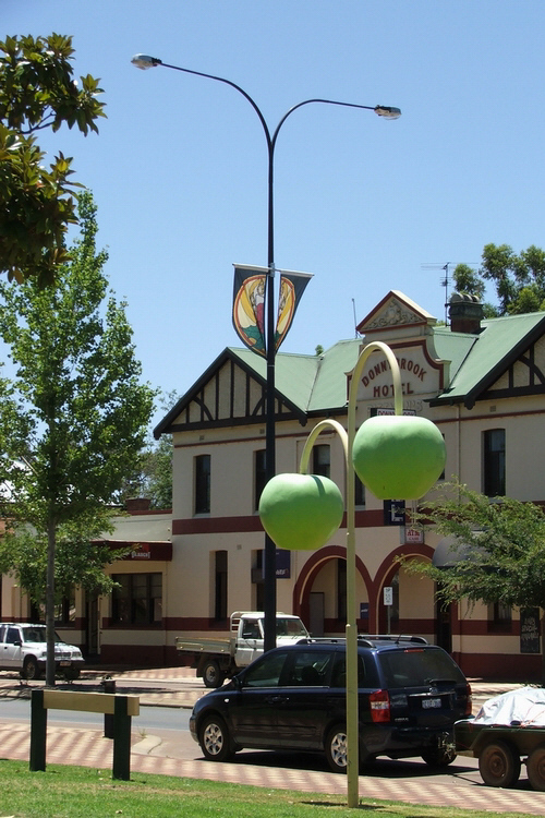 Photo of Donnybrook main street with Donnybrook hotel and apple lights in foreground. The apple is a symbol of Donnybrook, as it is West Australia's main apple growing region.